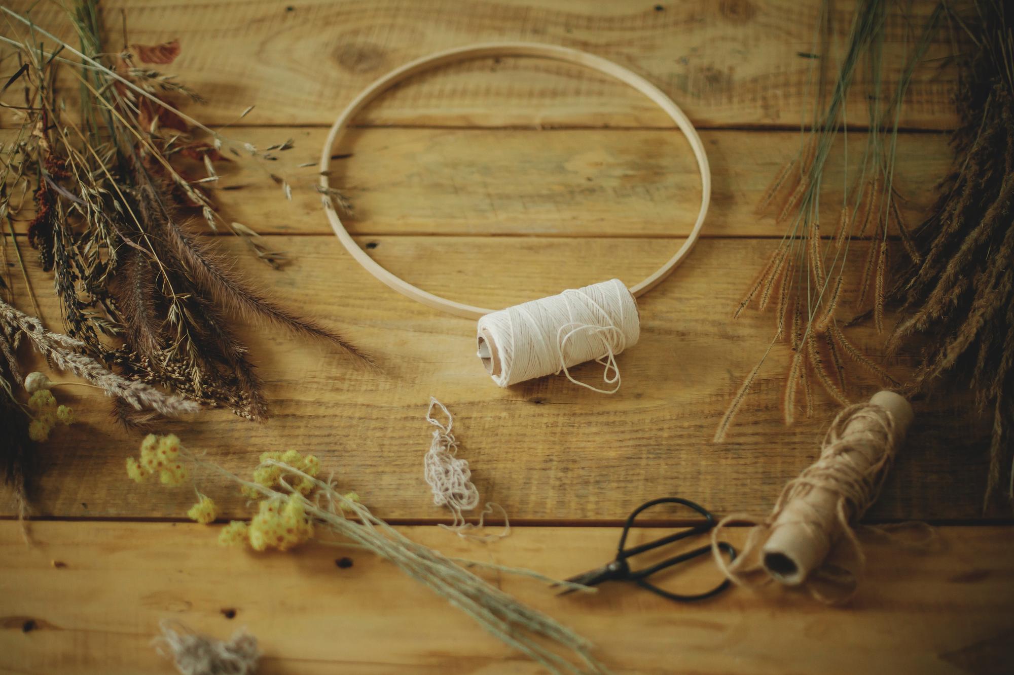 workbench with threads and embroidery hoop